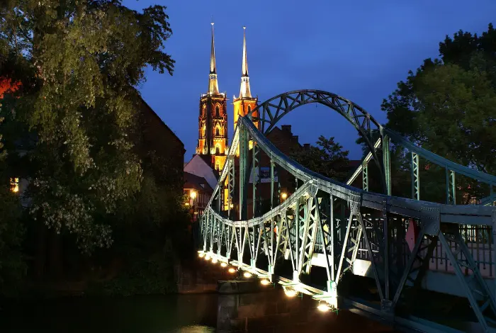 Oświetlony nocą Most Tumski nad Odrą